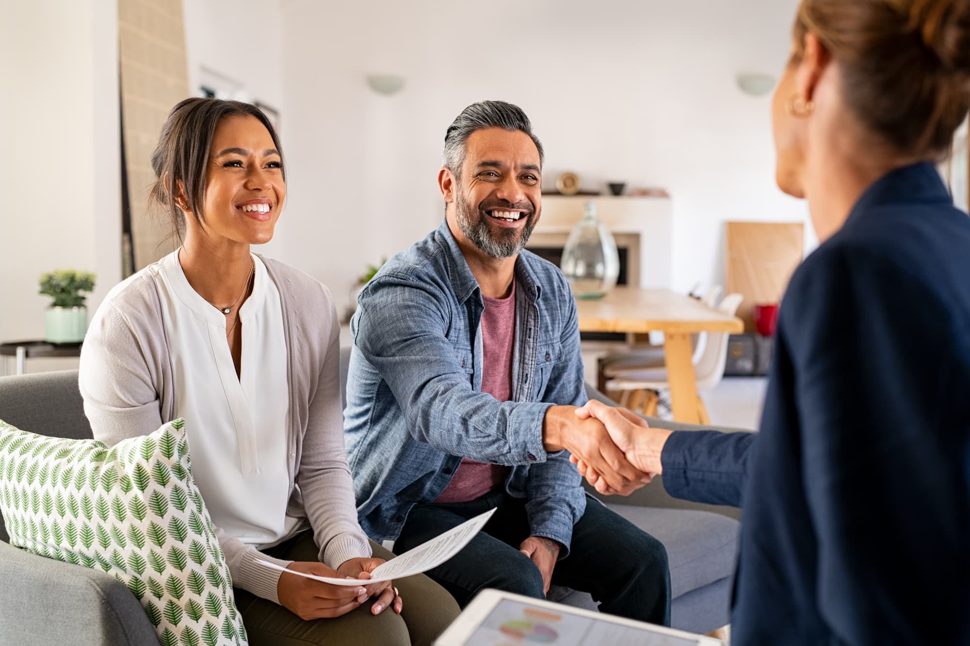 Couple shaking hands with an agent